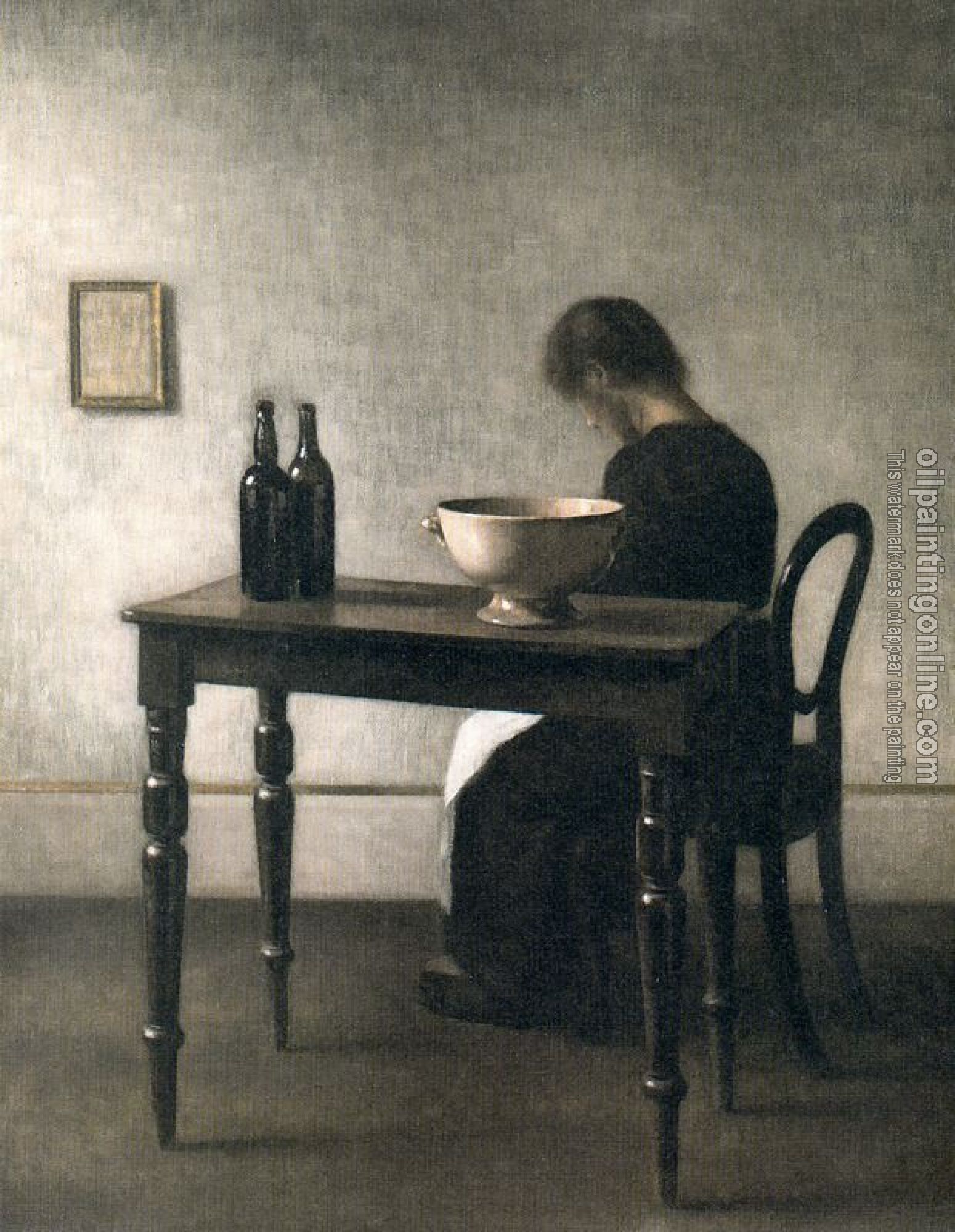 Vilhelm Hammershoi - Young woman sitting behind a table
